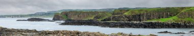 Panoramic sea landscape, the rocky coast on Dunseverick Harbour on Causeway Road, Bushmills, Co Antrim, Northern Ireland.	