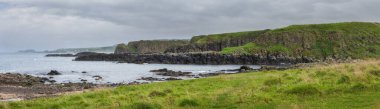 Panoramic sea landscape, the rocky coast on Dunseverick Harbour on Causeway Road, Bushmills, Co Antrim, Northern Ireland.	