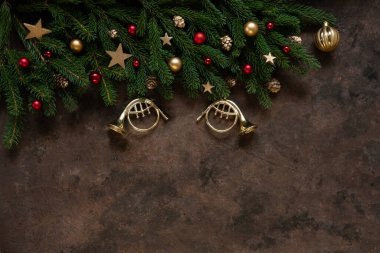 Christmas background with fir tree branches, Christmas decoration stars, balls, trumpets, cones. Top view, close up