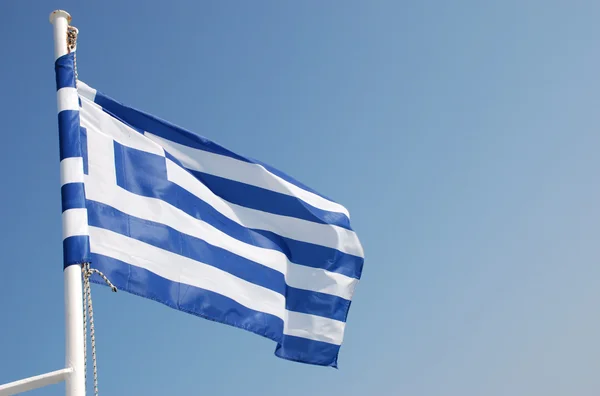 Greek flag on a background of a blue sky — Stock Photo, Image