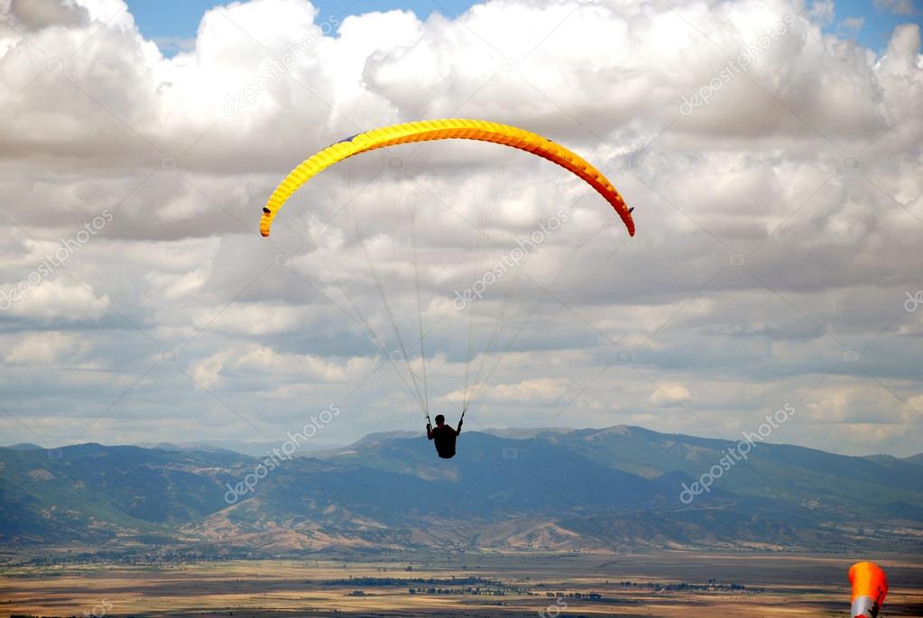 Paratrooper on the background of blue clody sky