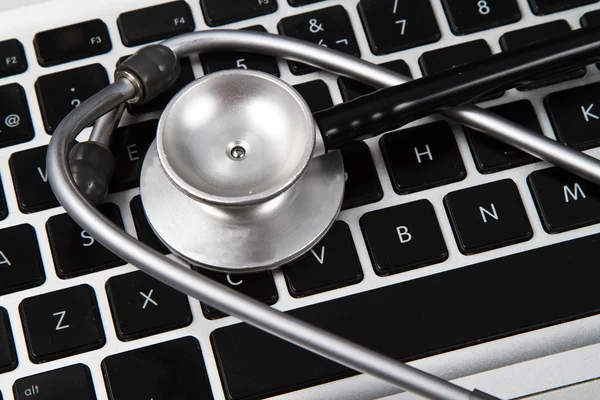 Stethoscope on a computer keyboard — Stock Photo, Image