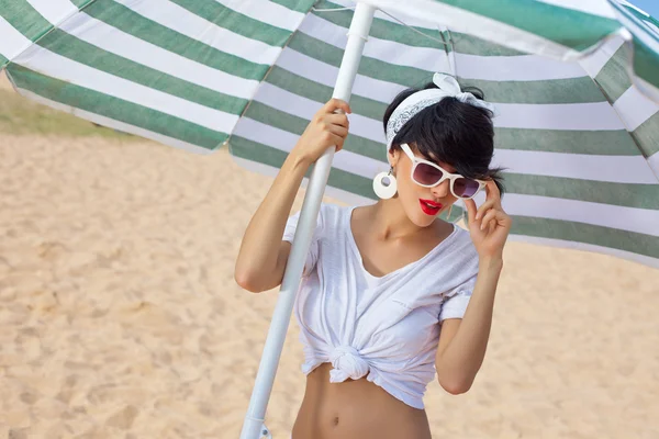 A beautiful young girl in retro look with red lips in a white sw — Stock Photo, Image