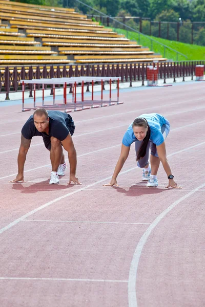 Man and woman on the starting line — Stock Photo, Image