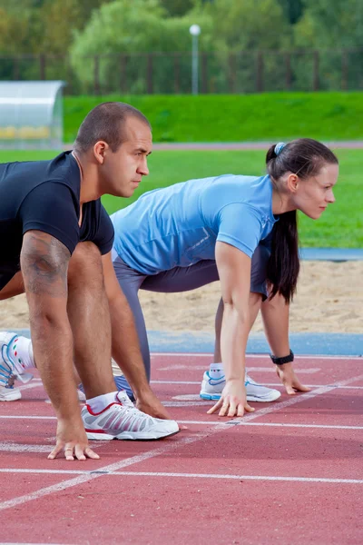 Man and woman on the starting line — Stock Photo, Image