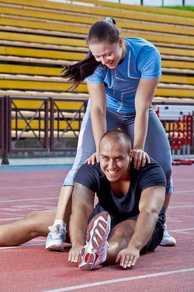 Man and woman at the stadium — Stock Photo, Image