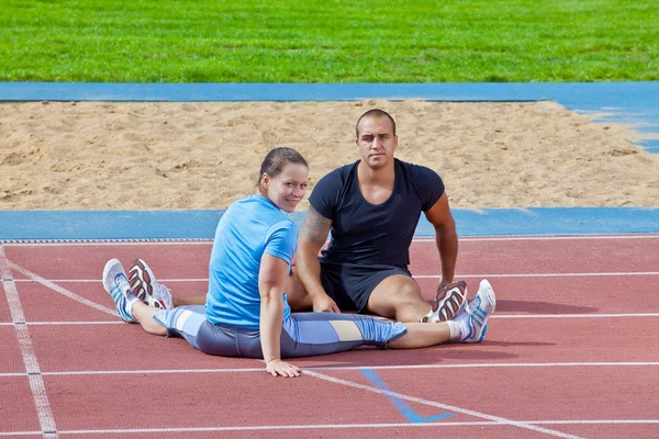 Man and woman at the stadium — Stock Photo, Image