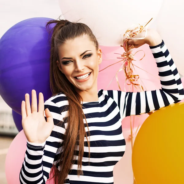 Beautiful lady in short black and white striped dress holds bunc — Stock Photo, Image