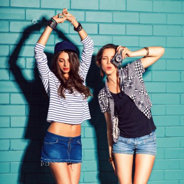 young people having fun in front of light blue brick wall clipart