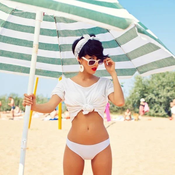 A beautiful young girl in retro look with red lips in a white sw — Stock Photo, Image