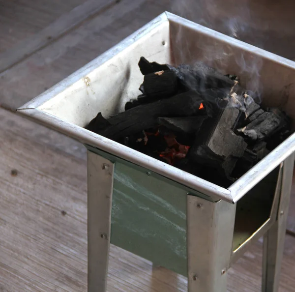 肉の調理や焙煎のための火を灯し始めるグリルストーブの上の炭の塊 — ストック写真