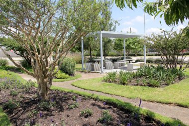 Güvenli ve güzel bir yerde aile ve mahalle için bankları, masaları ve oyunları olan açık hava topluluk alanı.