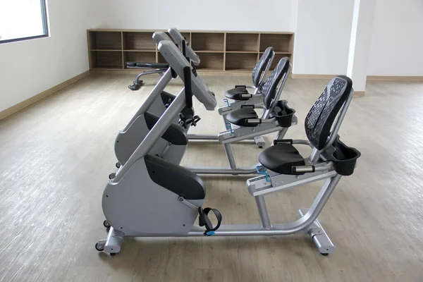 Kardiyo, tonlama bacakları, yanan kaloriler ve kilo vermek için spor salonunda duran siyah ve beyaz elektrikli düz bisiklet.