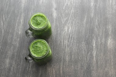 Sağlıklı ve besleyici bir kahvaltı için salatalık, pazı, ıspanak, limon ve meyve gibi sebzelerle servis edilen yeşil meyve suyu.