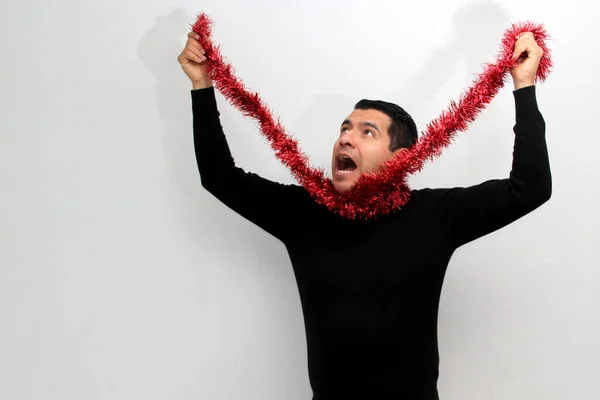 Dark Haired Latin Adult Man Hat Christmas Garland Shows His — Stockfoto