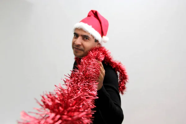 Dark Haired Latin Adult Man Hat Christmas Garland Shows His — Stockfoto