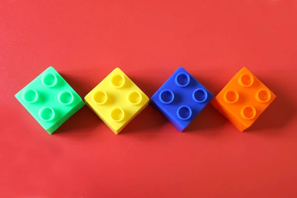 Buildable Colored Plastic Blocks Play Build Organize Red Background Concept — Stock fotografie