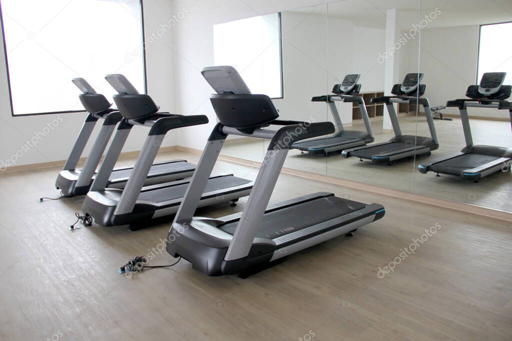 Brand new electric treadmills, exercise apparatus in gym of hotel or apartment building to have healthy and fitness lifestyle by doing cardio