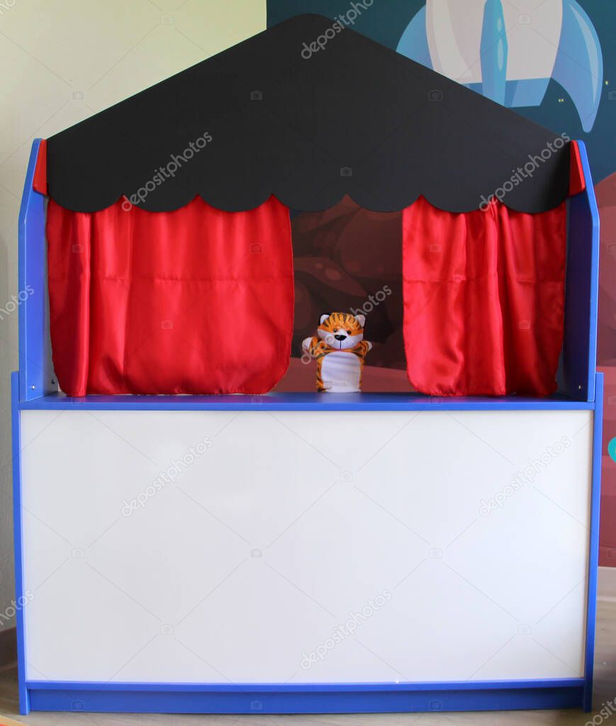 Guignol theater cultural and educational children's activity tells a story in a small replica of a theater with puppets or glove dolls moving their hands
