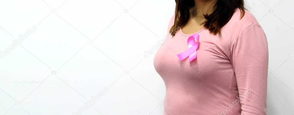 latin woman with pink blouse and pink ribbon for campaign against breast cancer on white background