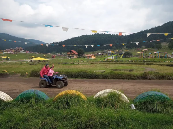 Latin bekar baba ve kızı, ormanın ortasında, ağaçlar ve doğa ile çevrili bir ATV 'de son sürat eğleniyorlar. Çok mutlu bir aile anı yaşıyorlar.