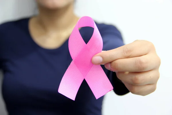 latin woman with blue blouse and pink ribbon for campaign against breast cancer on plain white background