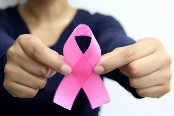 latin woman with blue blouse and pink ribbon for campaign against breast cancer on plain white background