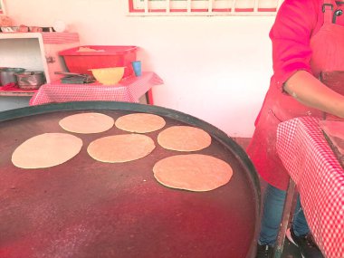 Meksika 'nın bir kasabasında mısır hamuruyla yeni yapılmış Meksika tortillaları taze, yumuşak ve lezzetli yemek için hazırlar.