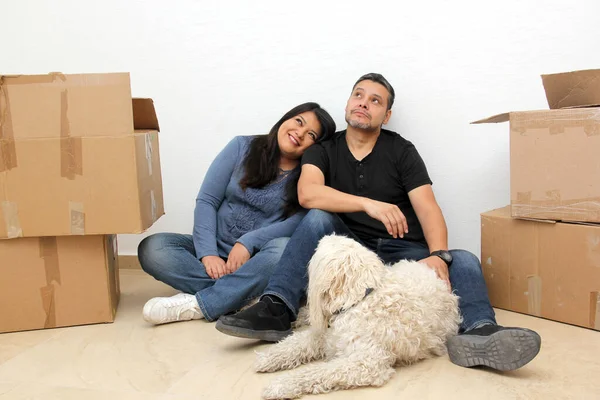 Couple of Latin man and woman move house thanks to a real estate agency they are happy for the beginning of a new life together and create a family