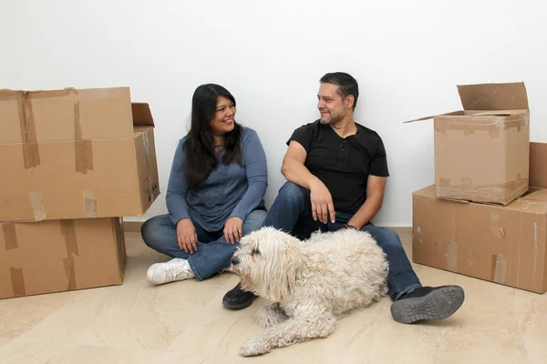 Couple of Latin man and woman move house thanks to a real estate agency they are happy for the beginning of a new life together and create a family