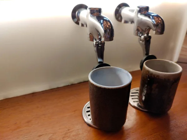 Hot water dispenser for brewing tea in a glass on a Japanese-style dining bar