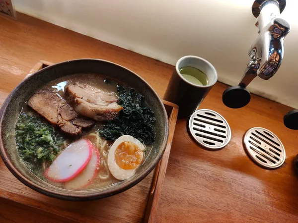 Delicious ramen, a Japanese noodle dish that consists of Chinese-style wheat noodles served in a meat-based broth, often flavored with soy sauce or miso, and uses toppings such as sliced pork or nori