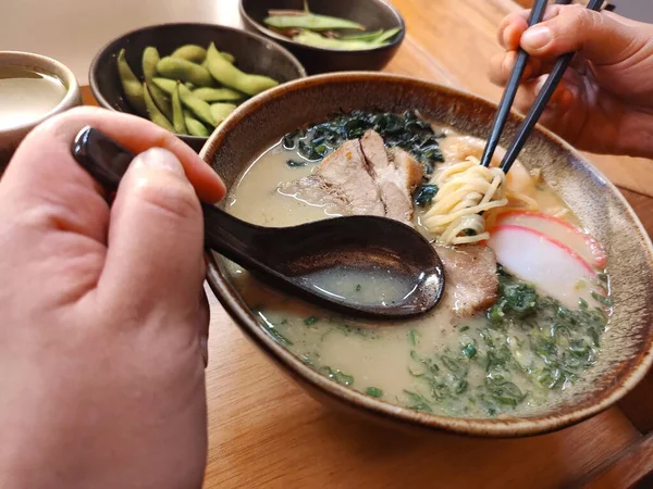 Delicious ramen, a Japanese noodle dish that consists of Chinese-style wheat noodles served in a meat-based broth, often flavored with soy sauce or miso, and uses toppings such as sliced pork or nori