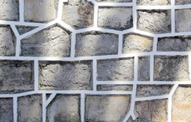 Gray stone wall between light and shadow as outdoor background