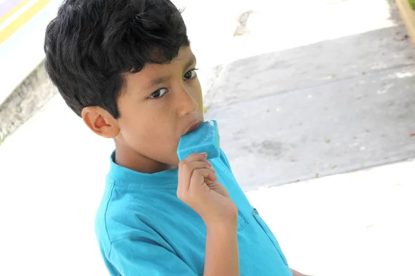 Poor Latino Dark Haired Boy Blue Shirt Sitting Park Bench — Photo