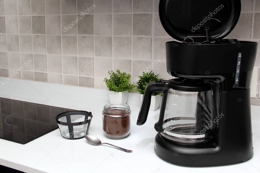 Freshly prepared coffee in a filter coffee machine served in white cups that is rich in antioxidants, fights Alzheimer's and Parkinson's, produces tachycardia and insomnia