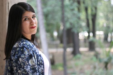 Divorced single Latin adult woman walks and dances in an outdoor park happy, full, calm, fulfilled and at peace