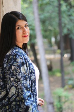 Divorced single Latin adult woman walks and dances in an outdoor park happy, full, calm, fulfilled and at peace