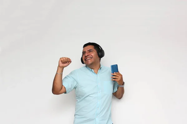 Latin Adult Man Uses His Wireless Headphones Cell Phone Listen — Fotografia de Stock