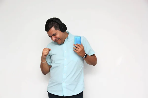 Latin Adult Man Uses His Wireless Headphones Cell Phone Listen — Stockfoto