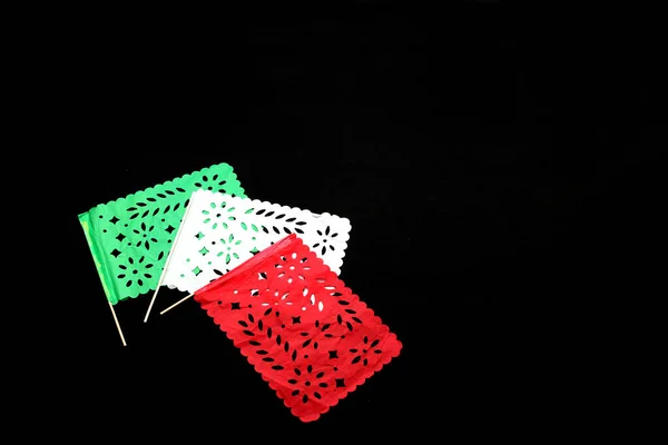 Mexican party pennants handmade with green, white and red cut-out paper like the flag of Mexico to celebrate the national holidays of independence