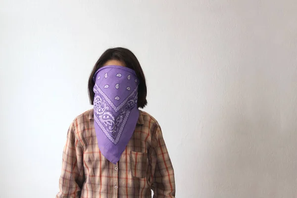 10-year-old Hispanic girl wears a purple headscarf representing the struggle for feminism and gender equality to commemorate International Women\'s Day on March 8