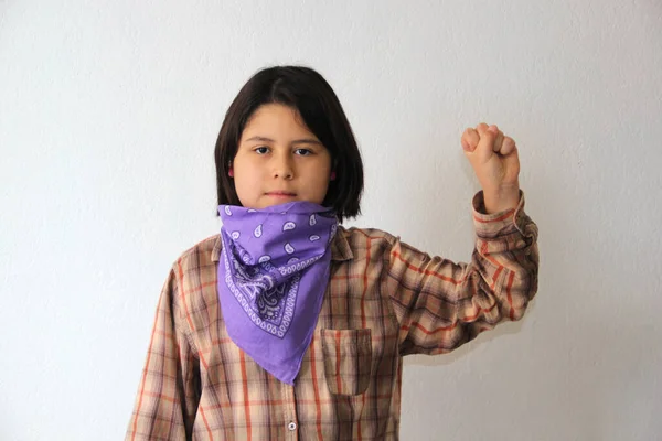 10-year-old Hispanic girl wears a purple headscarf representing the struggle for feminism and gender equality to commemorate International Women\'s Day on March 8