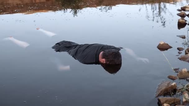 溺れた男が水中で死んだ湖の底に寝そべっていた若い男の死体汚れた池の死体不安定なカメラの動きの色補正 — ストック動画