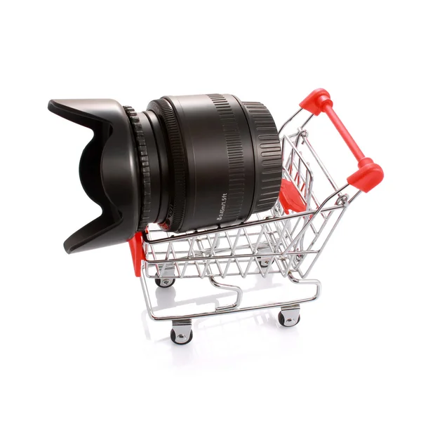 Camera lens with hood in shopping cart isolated on white — Stock Photo, Image