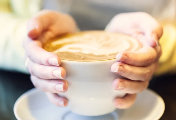 A cup of coffee in hands — Stock Photo, Image