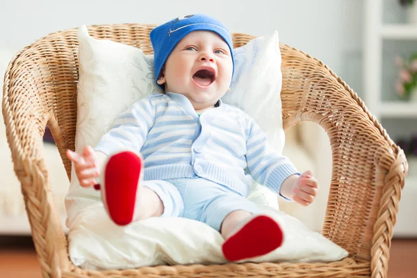 Boy is sitting on armchair — Stock Photo, Image