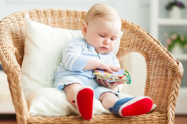 Boy is sitting on armchair — Stock Photo, Image