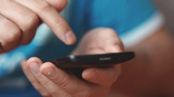 Mâinile apropiate ale unui om de nerecunoscut tastând un mesaj online folosind telefonul inteligent — Videoclip de stoc