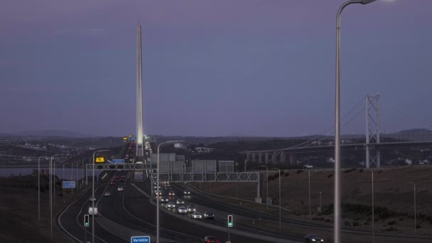 Real time footage of the road leading to the big bridge and moving cars at sunset — Video